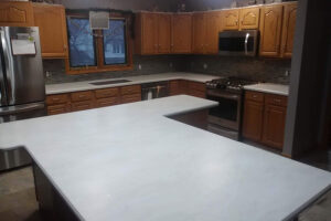 White acrylic countertops with unique design in a modern kitchen with stainless steel appliances and brown cabinets in Springfield, Illinois