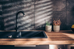 Matte black kitchen sink and faucet with a wooden countertop in Springfield, Illinois