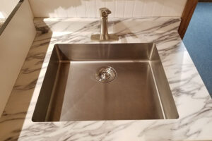A single basin sink with a sink strainer in the drain to catch food particles in Springfield, IL.