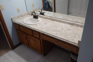 A newly installed laminate countertop with a marble or granite pattern in a bathroom in Glenarm, IL.