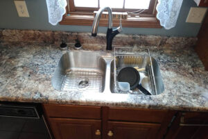A single-hole faucet from Kohler® mounted on a kitchen countertop in Glenarm, IL during a renovation project.