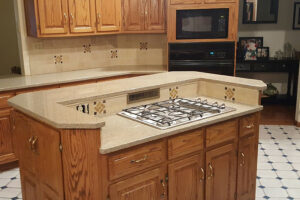 A quartz countertop installation service for a residential home in Glenarm, IL with brown cabinets and tile flooring.