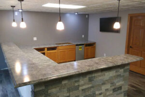 A downstairs basement bar with laminate countertops, laminate edges, and a laminate profile installed by Ray’s Countertop Shop in Central Illinois.