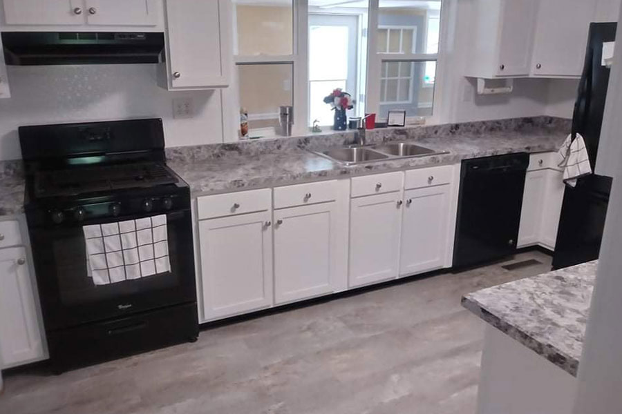 Laminate countertops that imitate grey and white stone that was installed in a residential kitchen in Springfield, IL from Ray’s Countertop Shop.