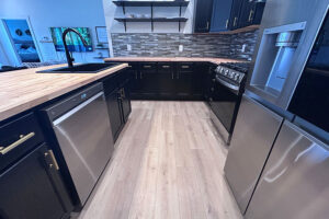 Light wood butcher block countertop in Glenarm, IL with matching hardwood floors and stainless steel appliances.