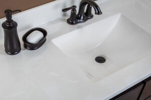 A white cultured marble countertop for a bathroom in Springfield, IL. A cultured marble countertop with a dark brown vanity and matching hardware.