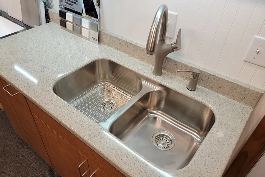 A solid surface countertop for a kitchen with a dual basin sink in Ray's Countertop Shop's warehouse in Glenarm, IL.