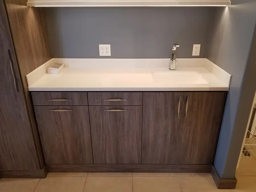 Ray's Countertop Shop Inc. - show room display, white solid surface countertop with faux wood laminate cabinets- ideal setup for kitchen or bathroom - Springfield, IL
