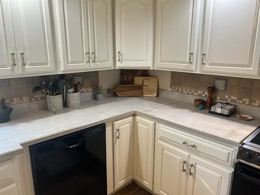 Ray's Countertop Shop Inc. - previous work, solid surface countertop, with white laminate cabinets, and rustic tile backsplash - Springfield, IL