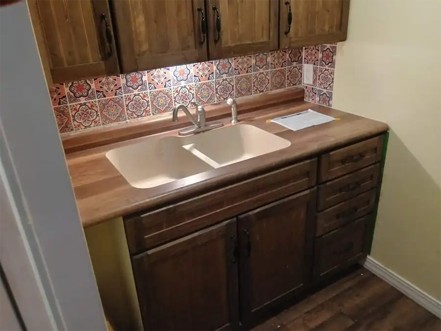 Ray's Countertop Shop Inc. -show room display, kitchen dual basin sink on faux wood laminate countertop, with colorful boho style tile backsplash - Springfield, IL