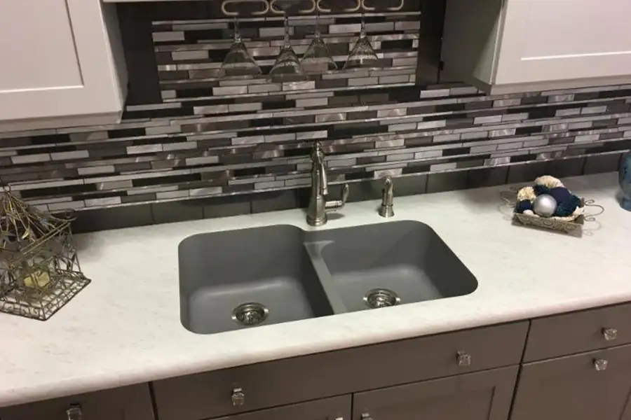 Mosaic tile backsplash behind a kitchen sink in the home of a Springfield, IL resident.