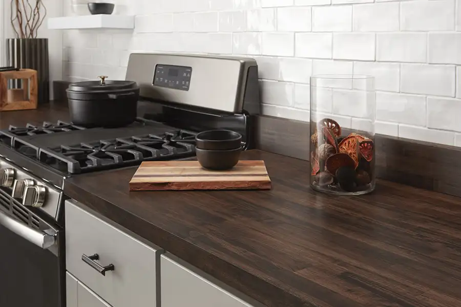 Dark butcher block countertop next to a stove in the home of a Springfield, IL resident.