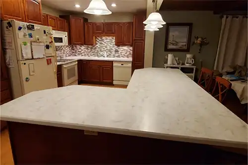 RAY'S COUNTERTOP SHOP INC. - Image of an island with solid surface countertops in the home of a Springfield, IL resident.