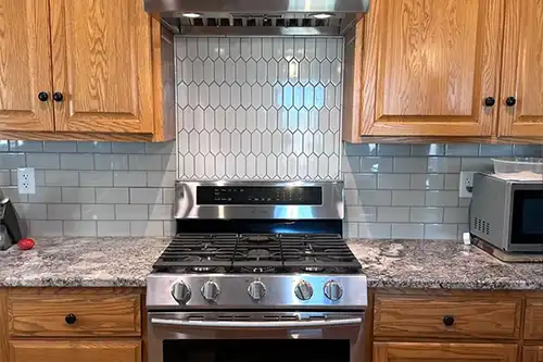 RAY'S COUNTERTOP SHOP INC. - A kitchen in Springfield, IL with a mixture of subway and picket tiles.