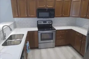 RAY'S COUNTERTOP SHOP INC. - Newly installed white laminate countertop in the kitchen of a Springfield IL, homeowner.