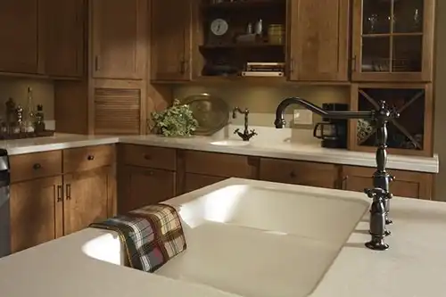 RAY'S COUNTERTOP SHOP INC. - Matte black faucet on top of a neutral-colored countertop in the home of a Springfield IL, resident.