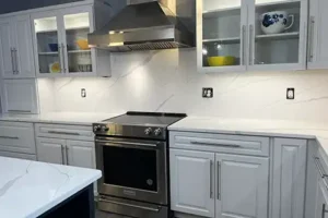 RAY’S COUNTERTOP SHOP INC. - Kitchen in Springfield IL, with white cabinets, countertops, and backsplash.