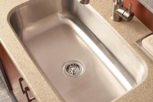 RAY'S COUNTERTOP SHOP INC. - Close-up image of a silver undermount sink in the kitchen of a Springfield IL, home.