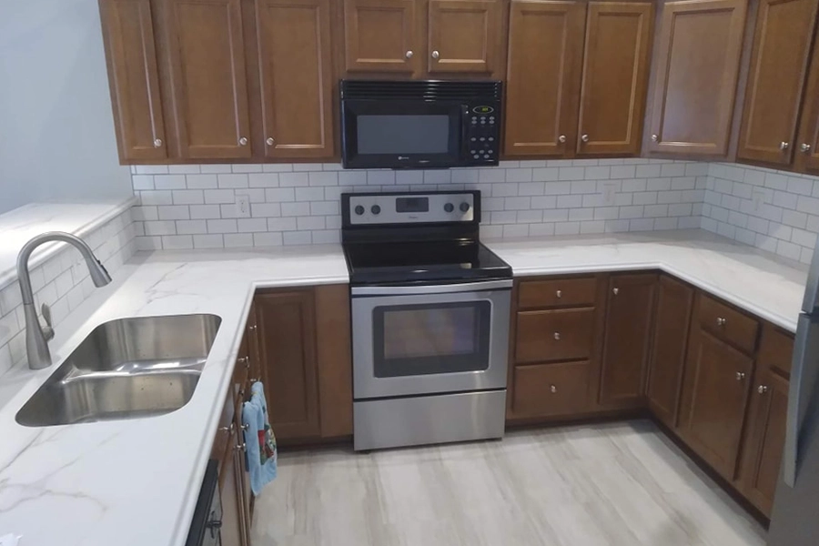 RAY'S COUNTERTOP SHOP INC. - Newly installed white laminate countertop in the kitchen of a Springfield IL, homeowner.