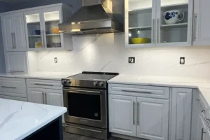 RAY’S COUNTERTOP SHOP INC. - Kitchen in Springfield IL, with white cabinets, countertops, and backsplash.