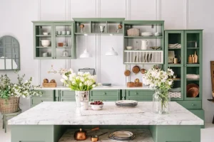 Ray’s Countertop Shop—A kitchen with marble countertops and open shelving painted green in a home in Glenarm, IL.