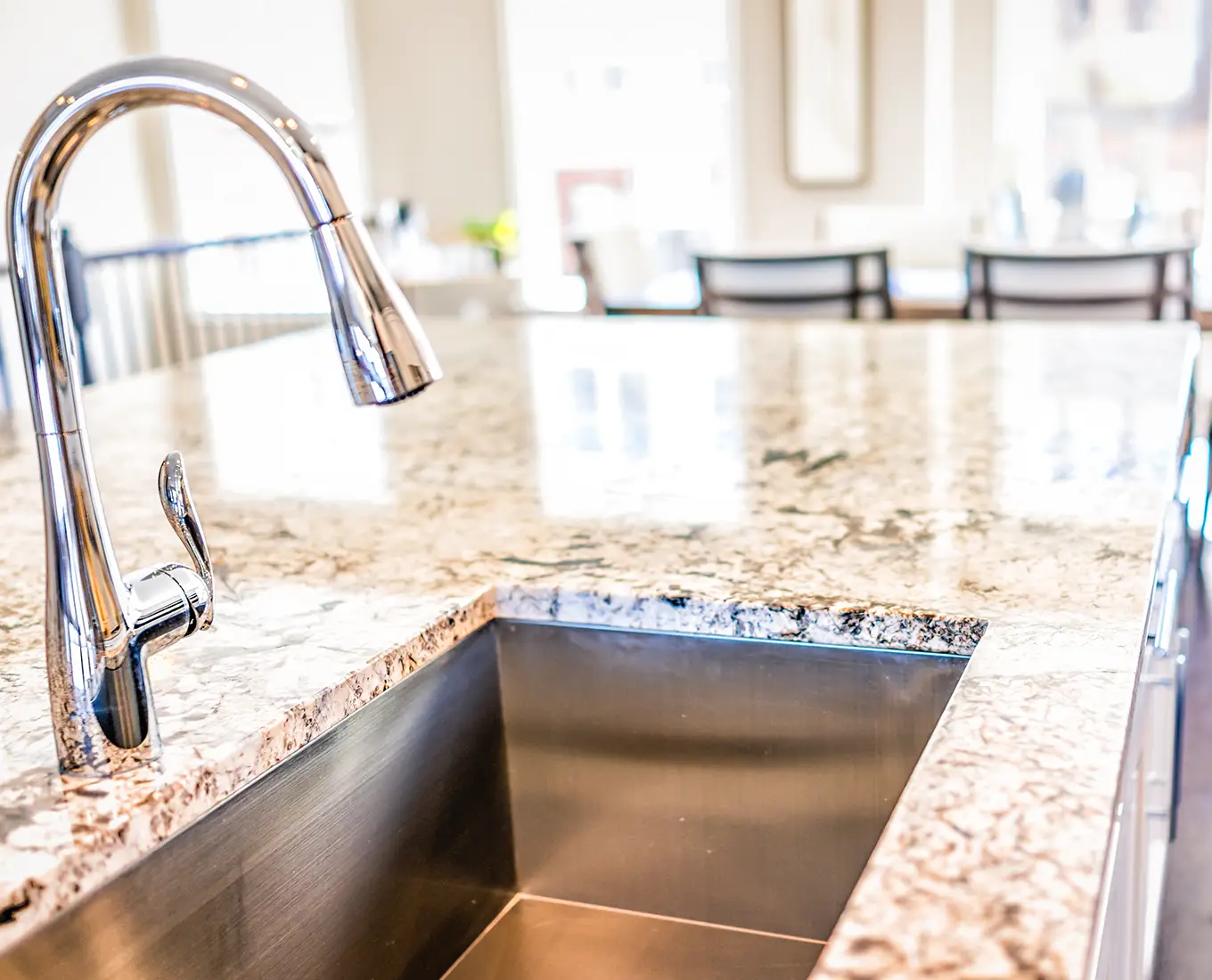 under mount single-basin sink with chrome colored faucet on granite countertop in modern kitchen - Springfield, IL